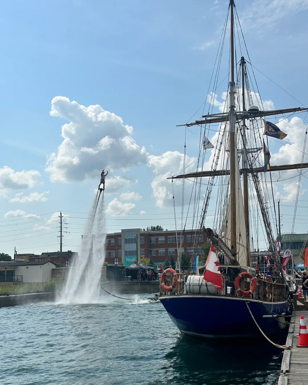 Flyboard show taking place beside a tall ship at a Collingwood waterfront