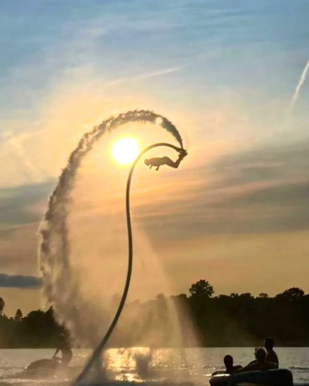 Flyboard rider completing a sunset flip above Georgian Bay