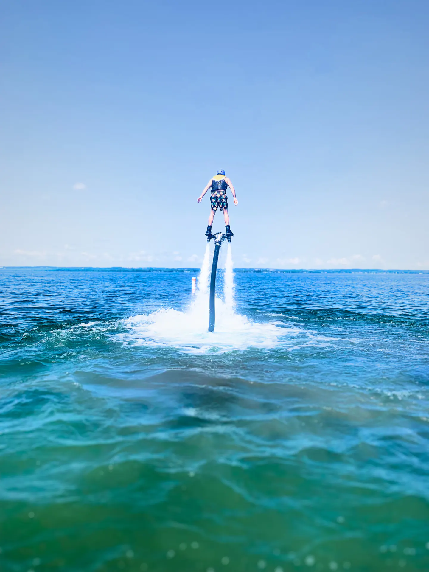 Flyboard rider rising over the open blue water of Lake Simcoe